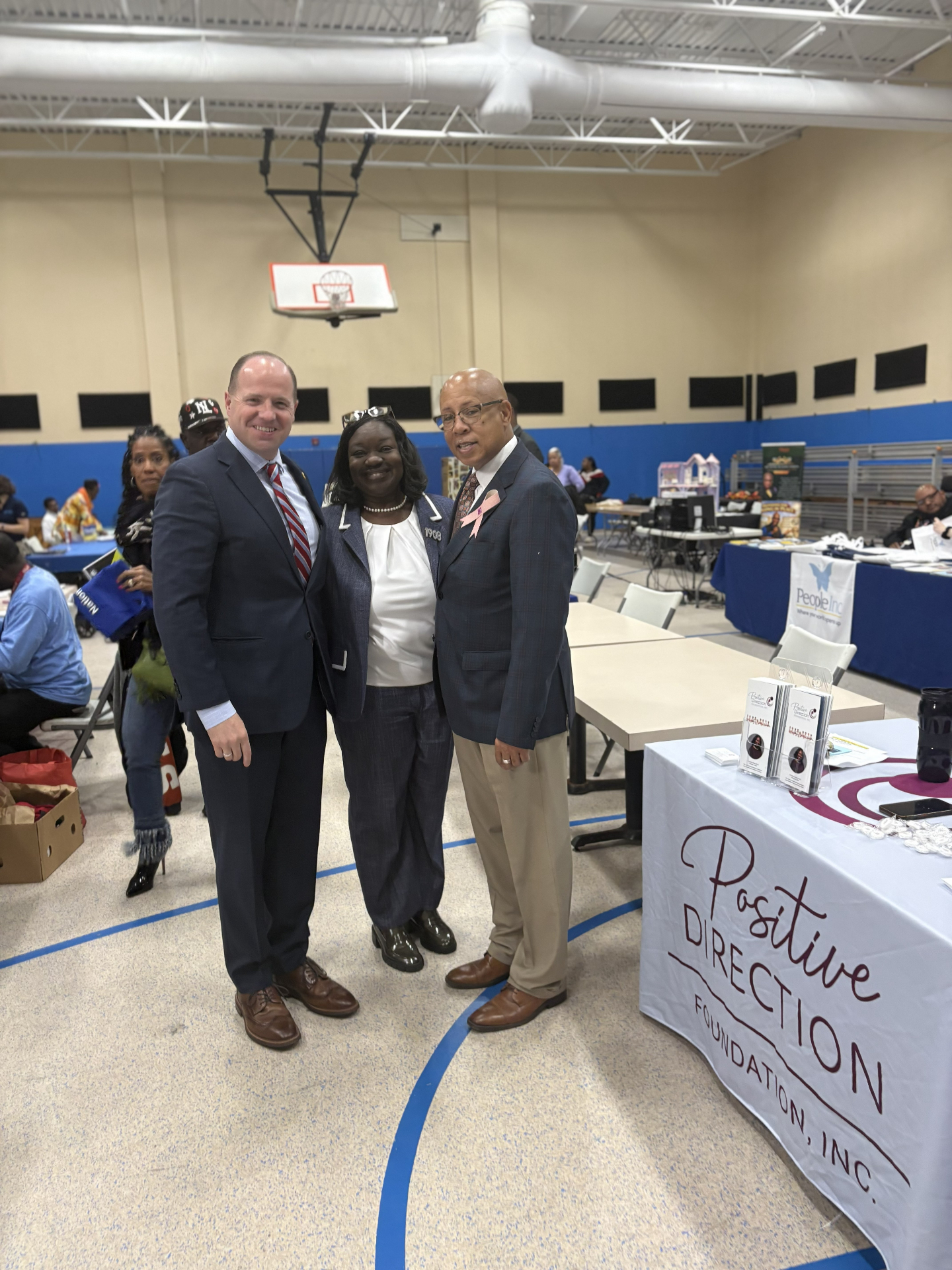 Community members together at the Positive Direction Foundation outreach table